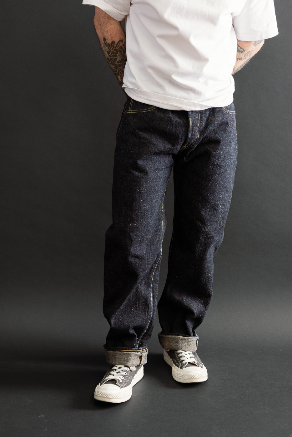 Front view of dark indigo selvedge jeans on a male model, 5'9