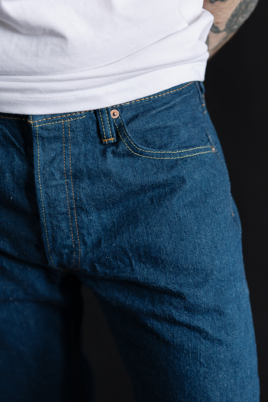 Close-up front view of Pure Blue Japan 14oz greencast indigo selvedge jeans on male model, 5'9