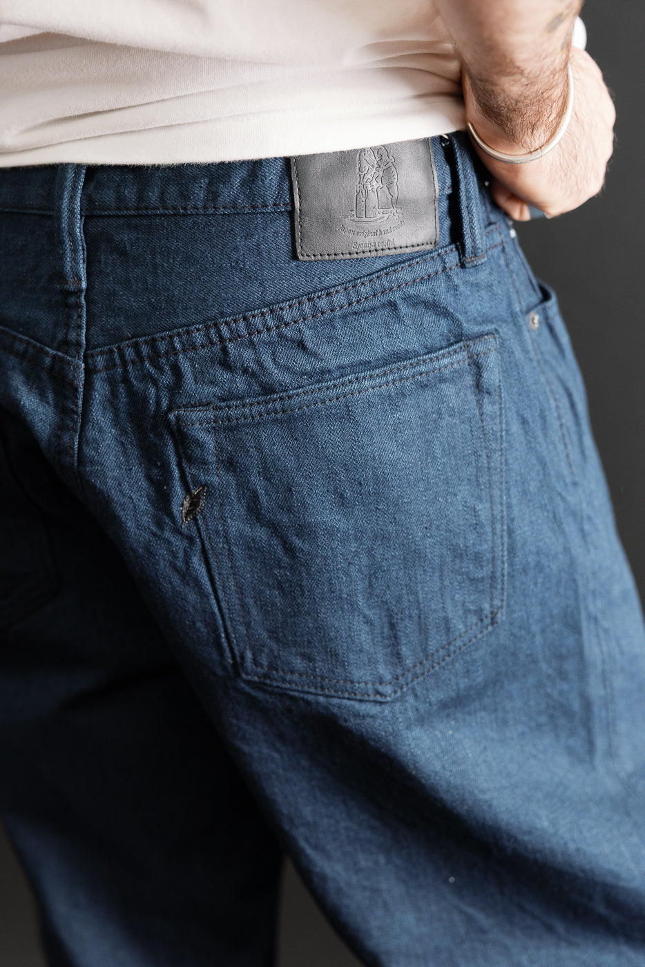 Close-up back view of blue selvedge denim jeans on a 5'9