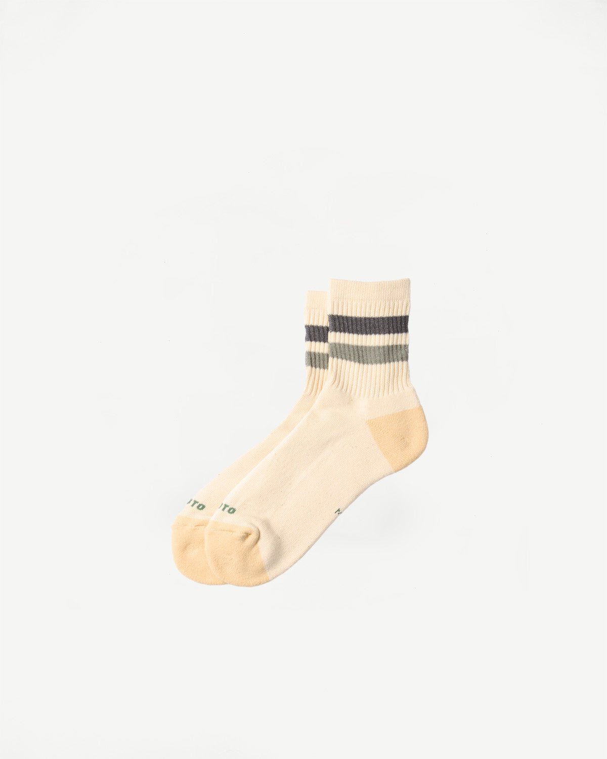 Flat lay front view of retro athletic ankle socks in cream with charcoal and olive stripes.
