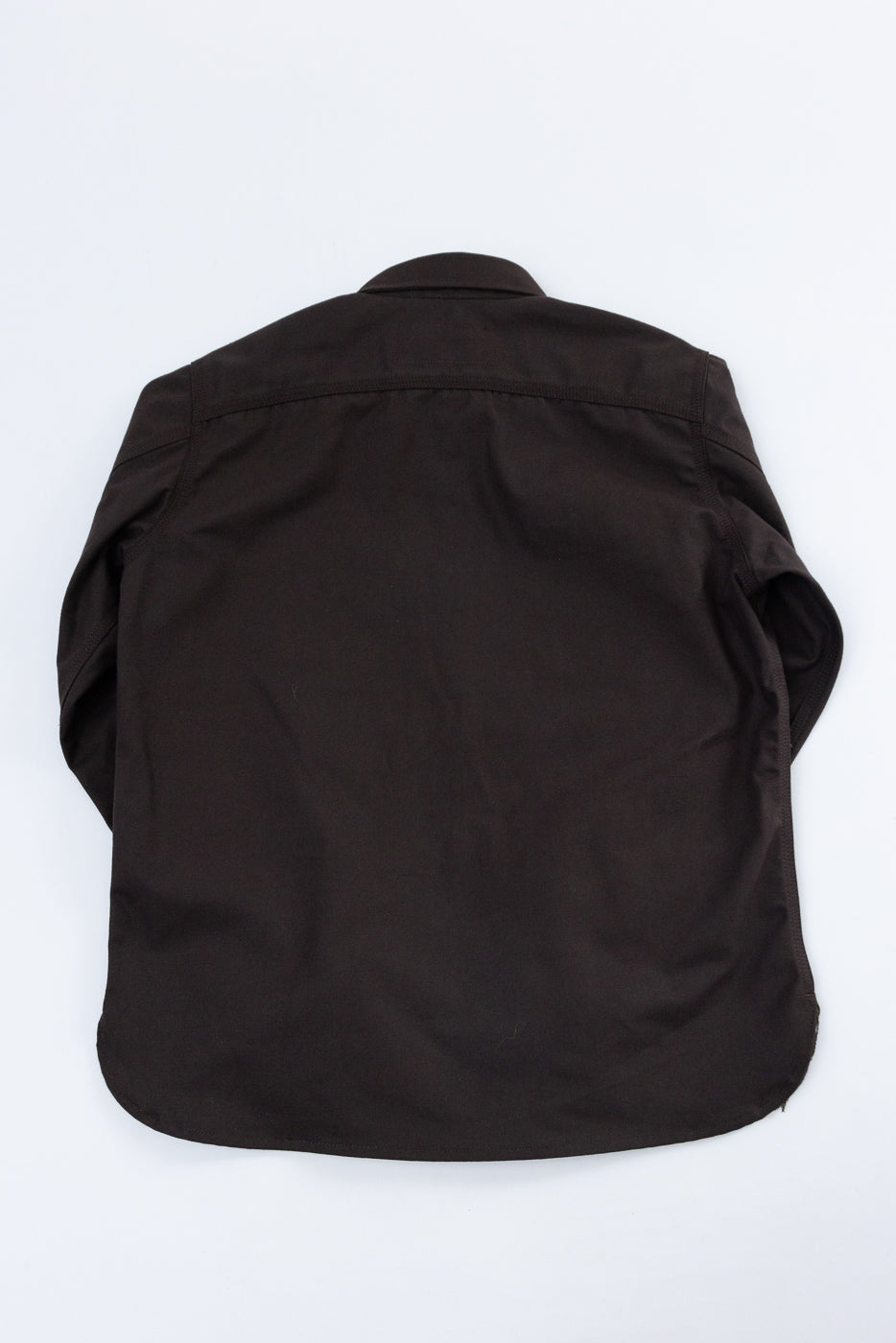 Back view flat lay of a black long-sleeve button-down shirt showing the rear panel and hem.