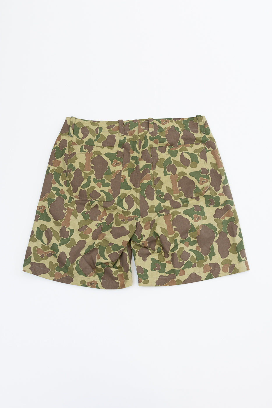 Back view of camouflage shorts with two rear pockets, flat lay on white background