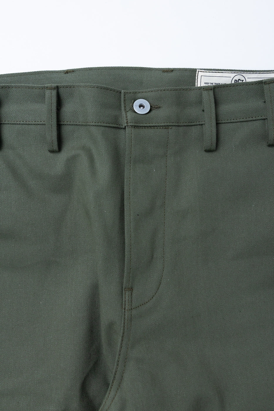 Close-up front view of olive green officer high trouser, button and belt loops visible