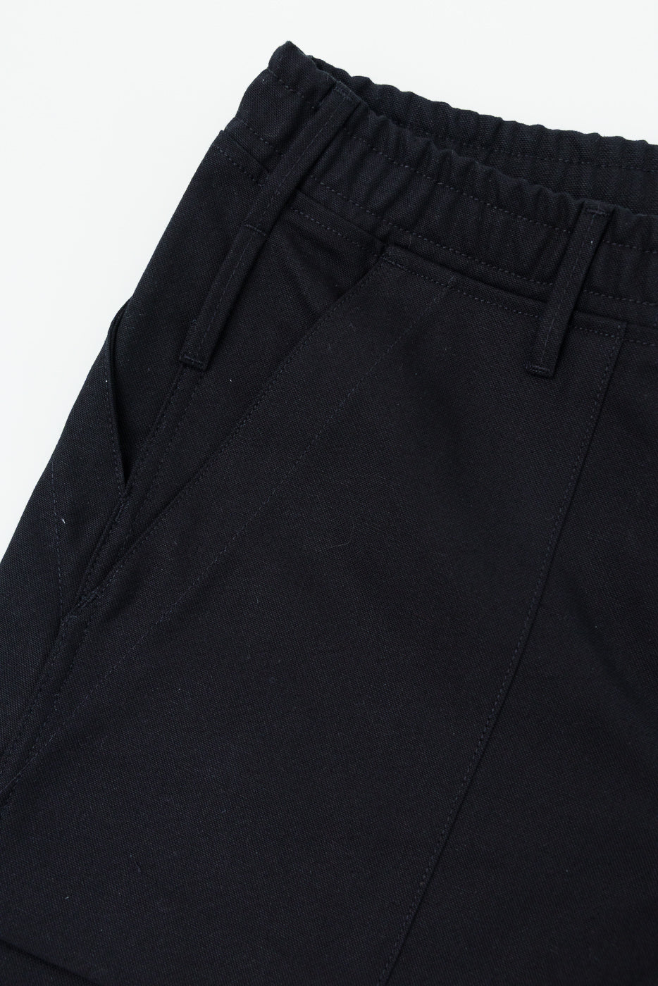 Close-up front view of black casual pants with elastic waistband and side pockets