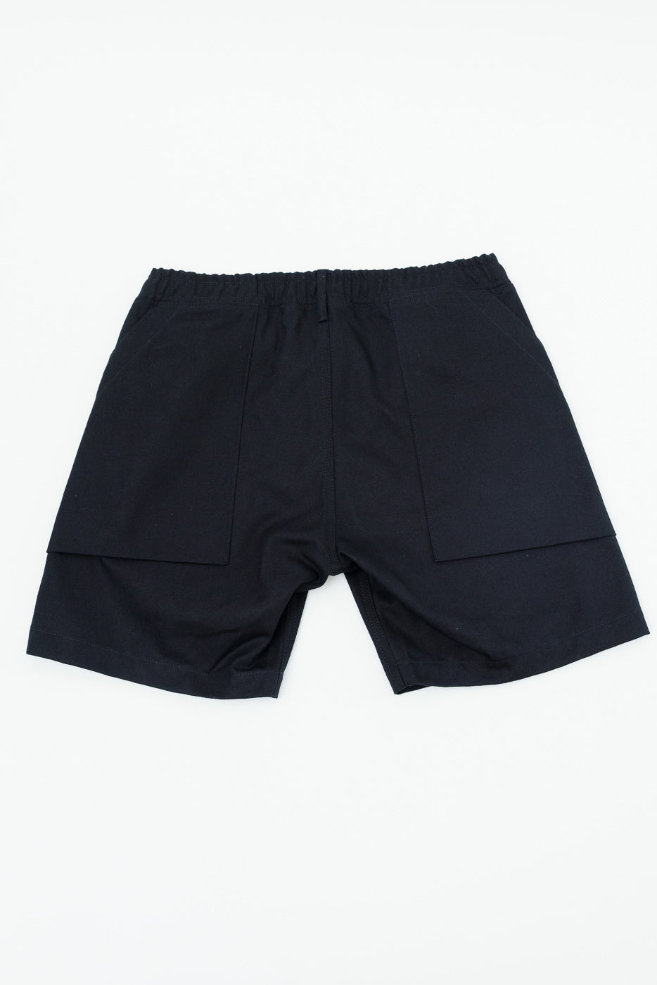 Back view of black casual shorts with elastic waist and side pockets, flat lay