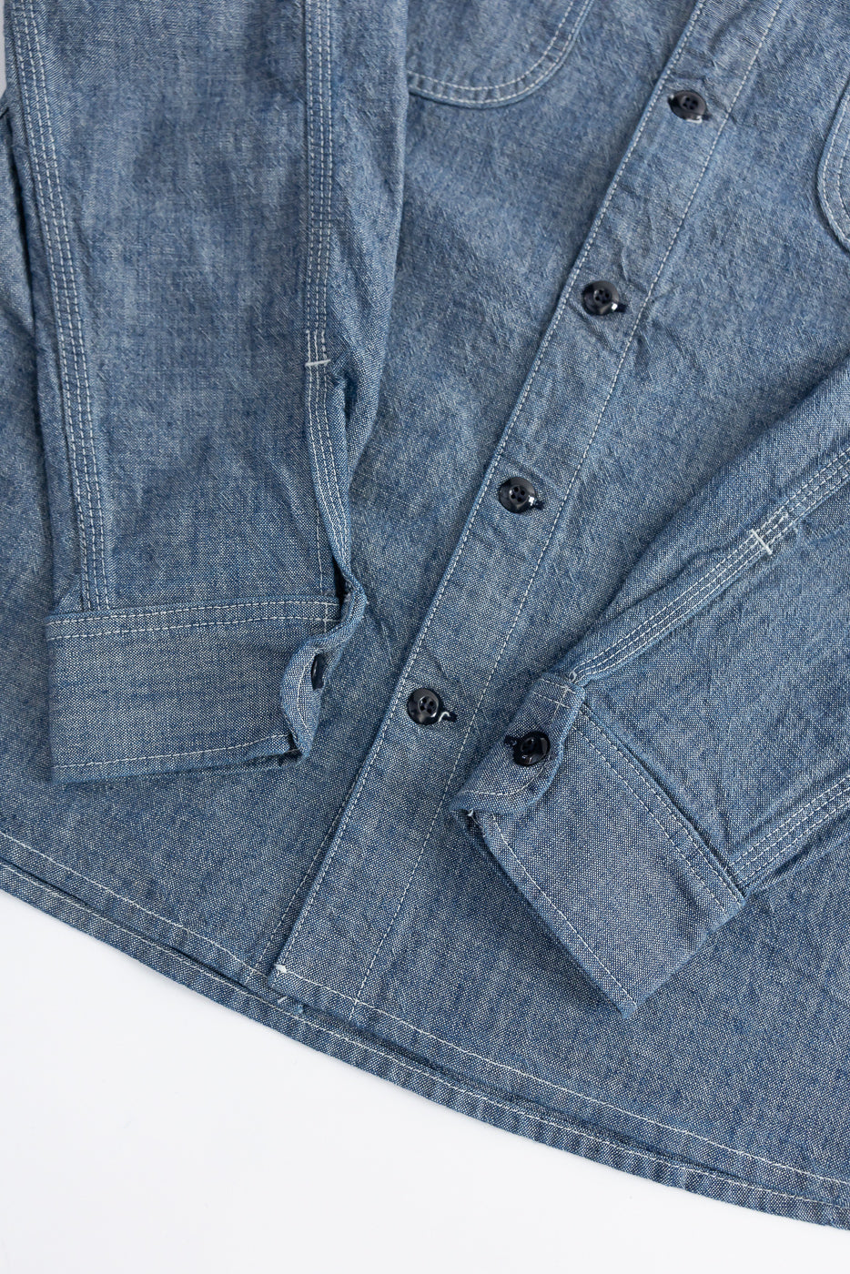 Close-up of Rogue Territory work shirt front, rinsed indigo canvas, showing cuffs and buttons.