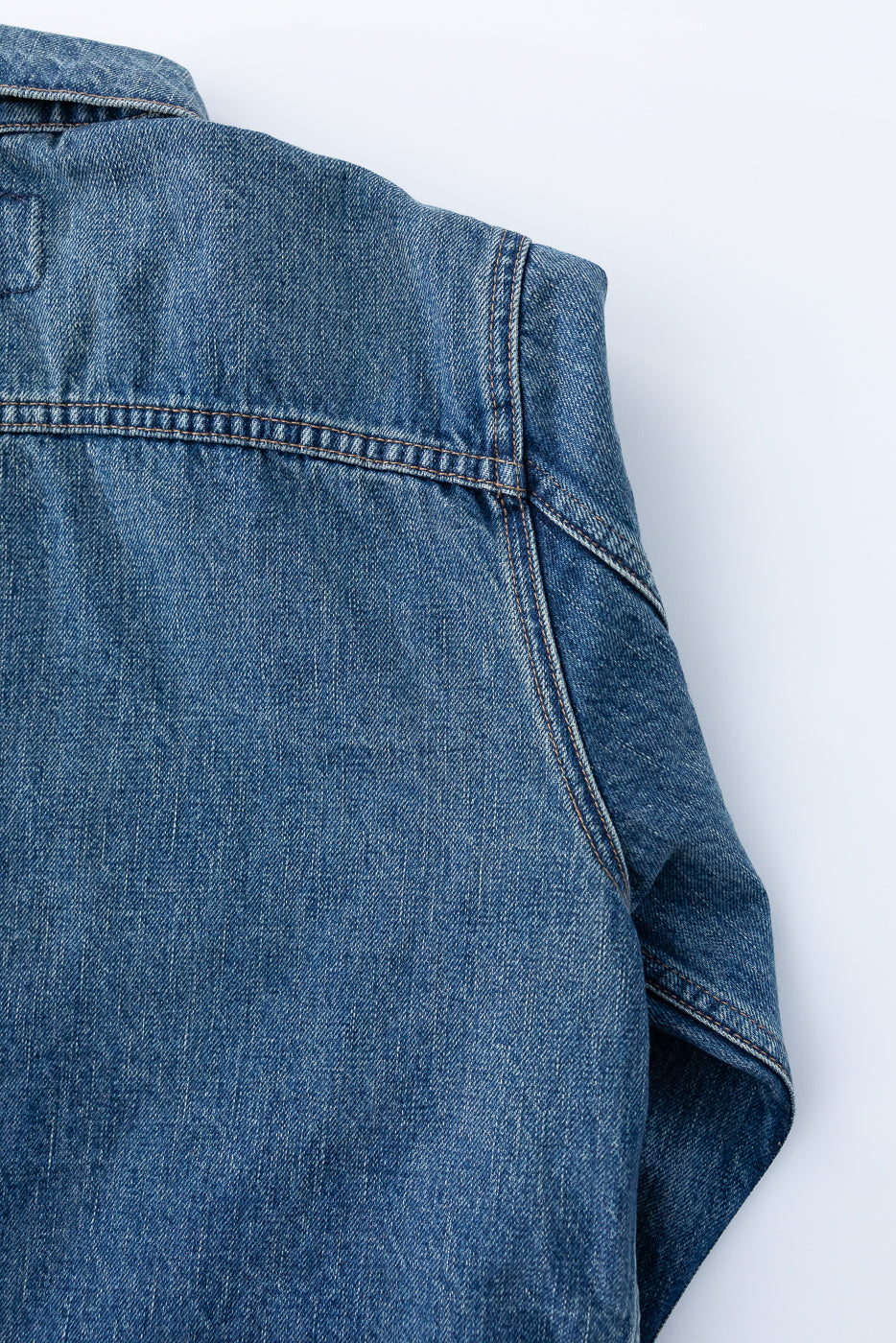 Close-up front view of men's denim shirt showing collar, chest pocket, and stitch details