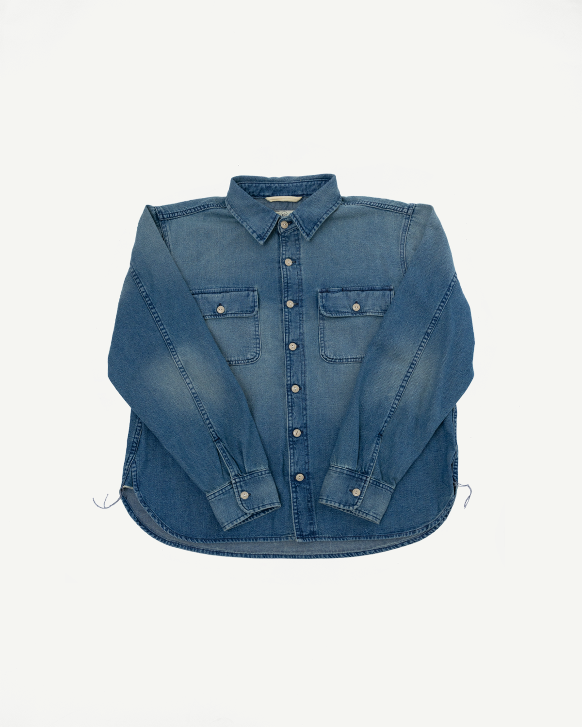 Front flat lay of men's blue denim shirt with button-down collar, chest pockets, and long sleeves