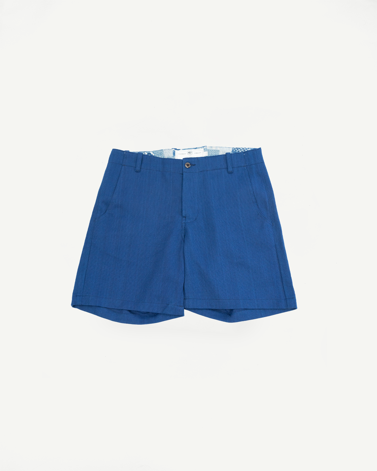 Front view of blue textured shorts with button closure and patterned lining, flat lay