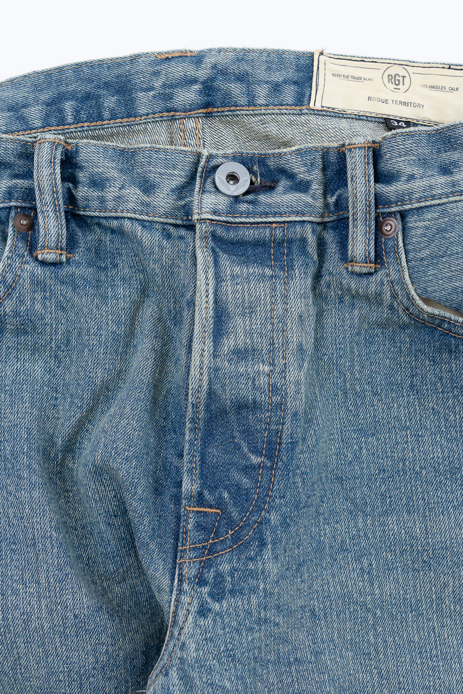 Close-up front detail of Rogue Territory RGT selvedge denim jeans, waistband, button, and pocket