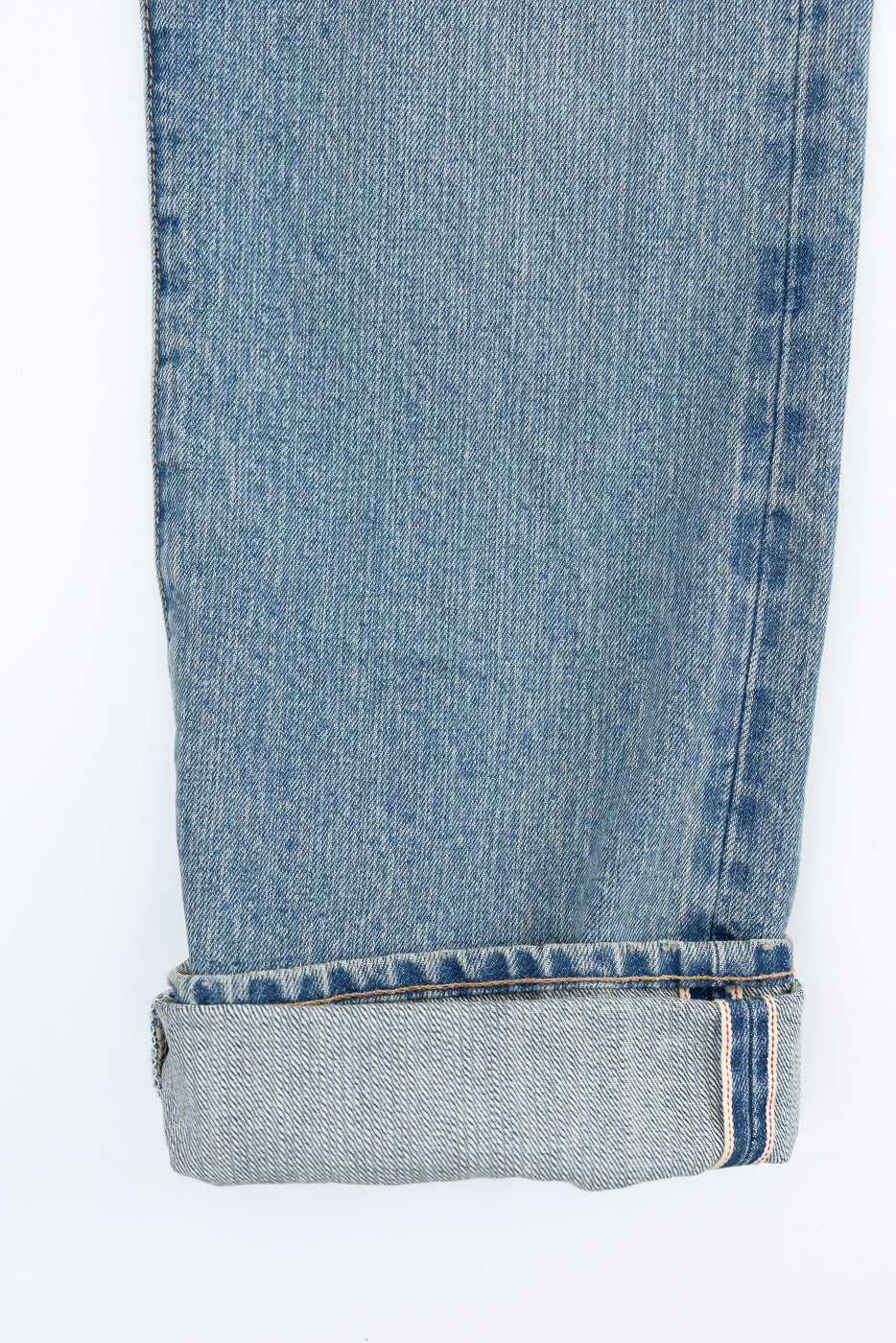 Close-up of front lower leg and cuff on Rogue Territory 15oz river washed selvedge jeans, indigo, showing selvedge ID detail and denim texture.