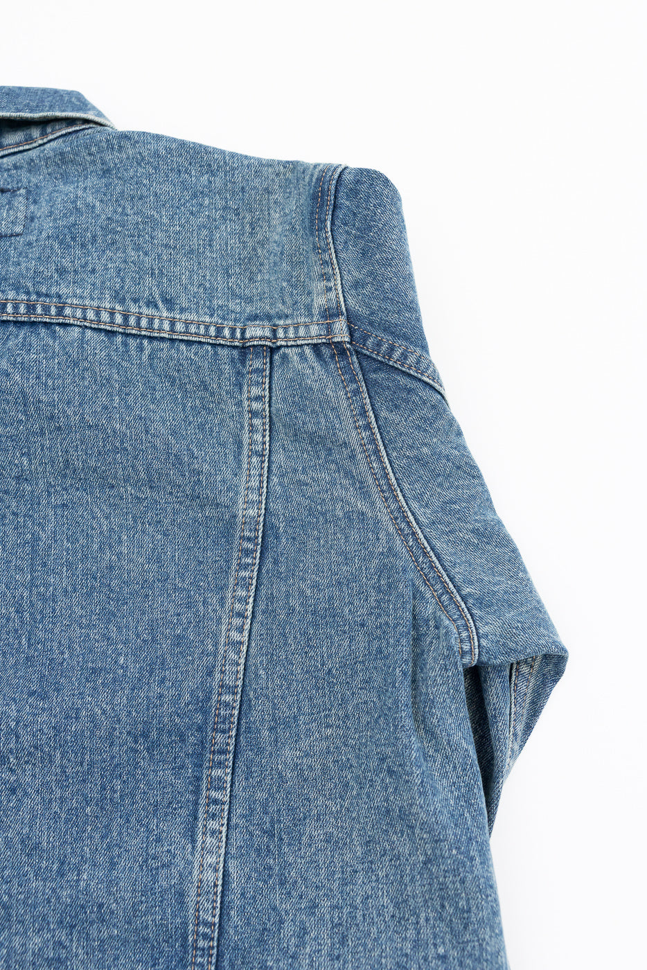 Close-up front view of men's denim shirt showing collar, shoulder seam, and fabric texture