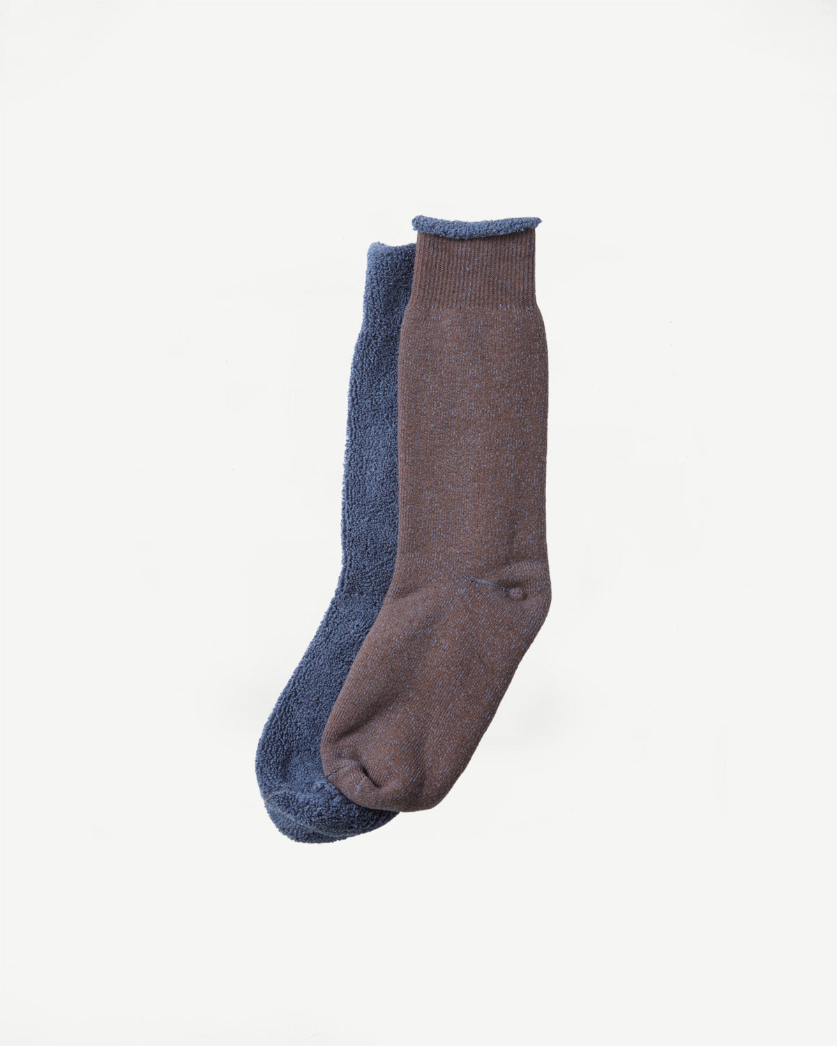Flat lay showing the front of a pair of blue and brown textured socks.