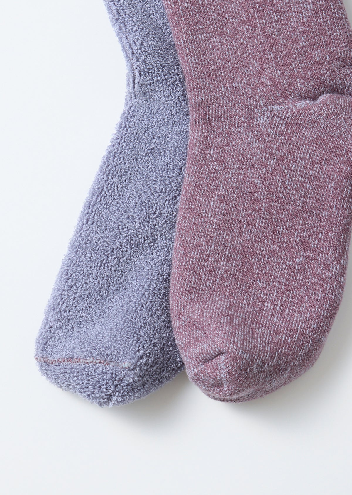 Close-up of the front view showing the thick, textured fabric of a purple and mauve sock pair.