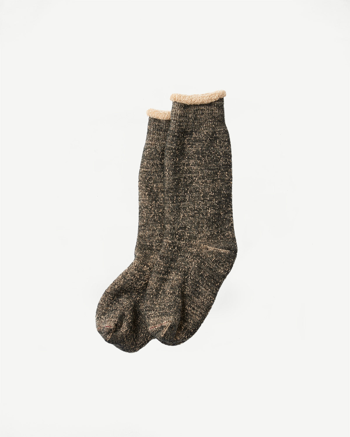 Flat lay front view of thick, dark grey marl textured knit socks with tan cuffs.