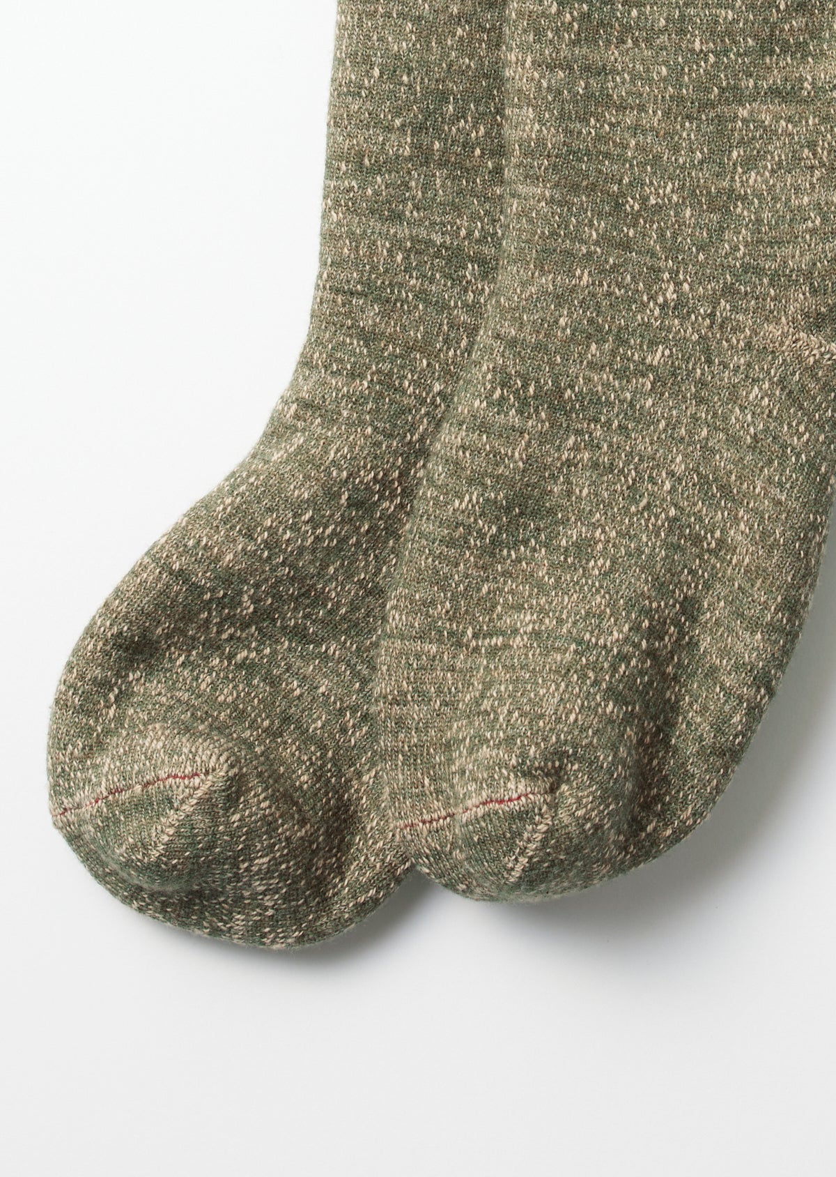 Close-up of the toe area of a pair of green marled textured socks.