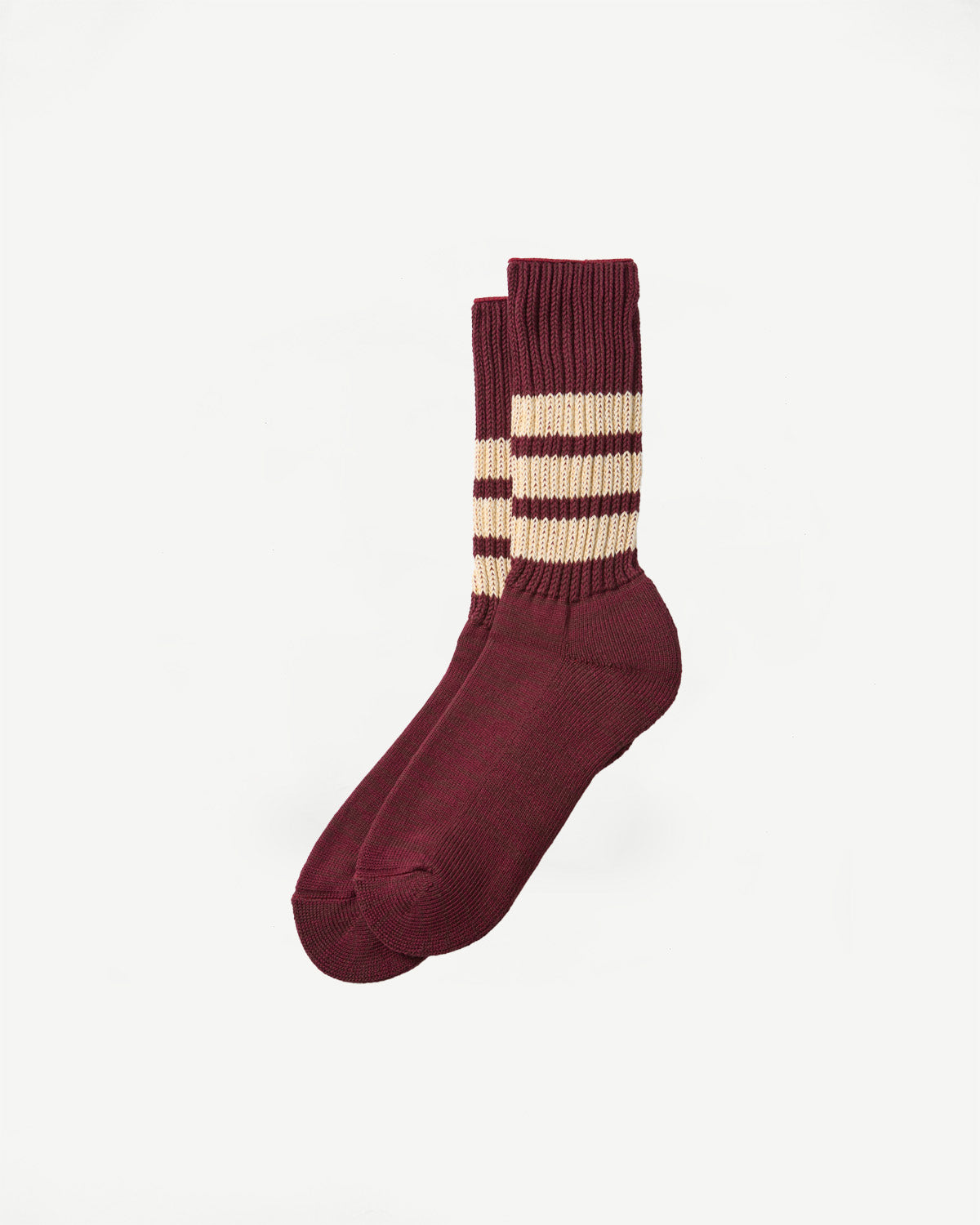 Side view of maroon crew socks with three cream stripes on the cuff, shown against a white background.