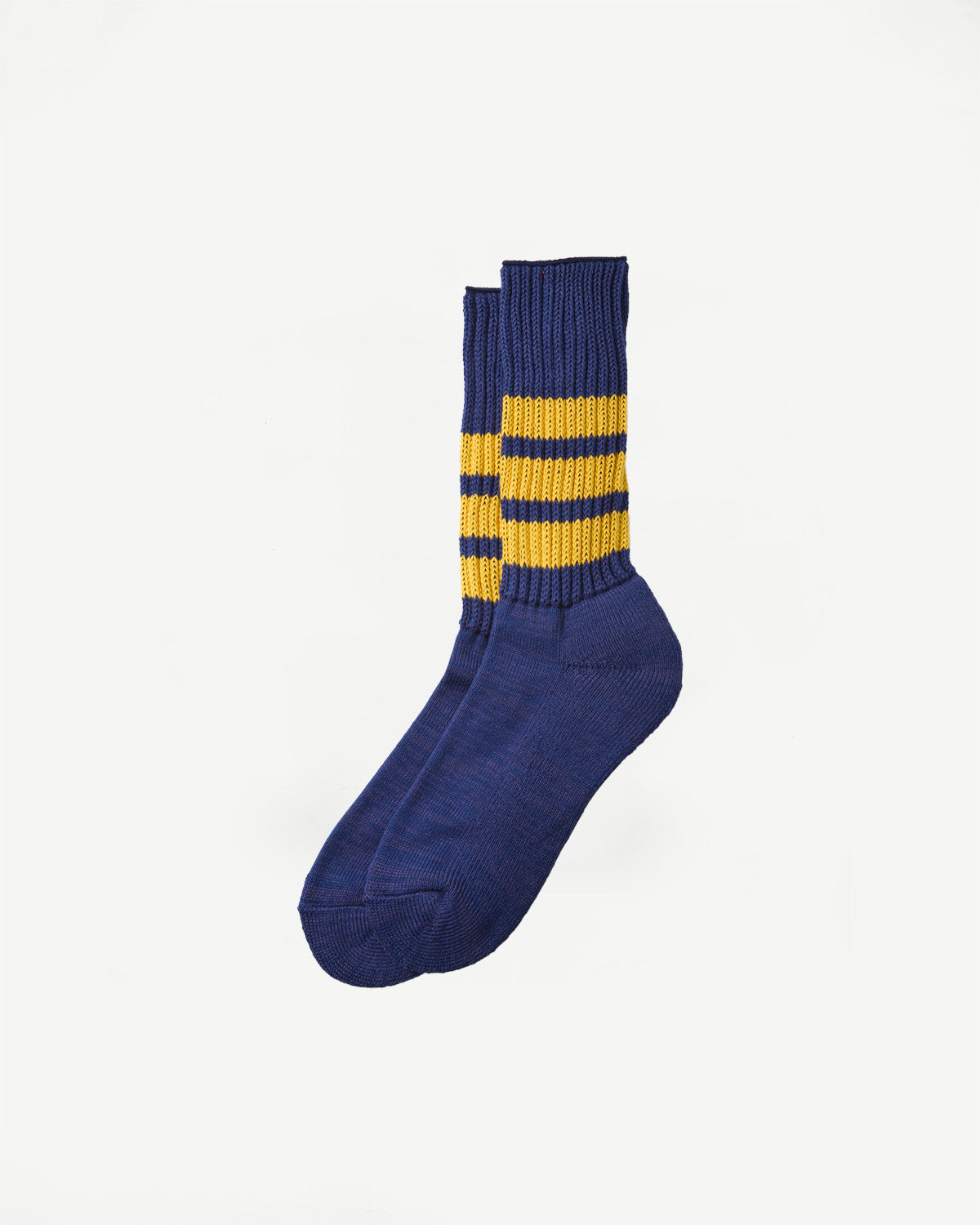 Flat lay, side view of navy blue ribbed crew socks with three yellow stripes.