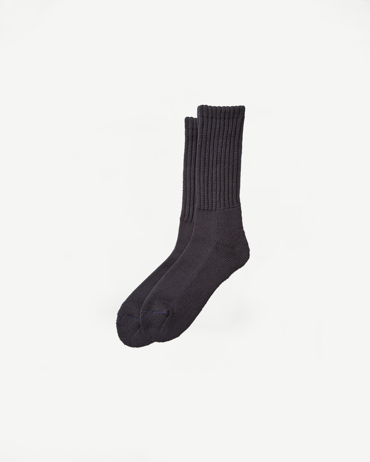 Flat lay of charcoal crew socks, front side, showing ribbed cuffs and soft knit texture.