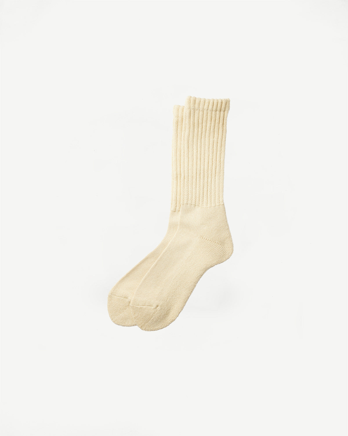 Flat lay front view of raw beige crew socks with ribbed cuff and soft texture.
