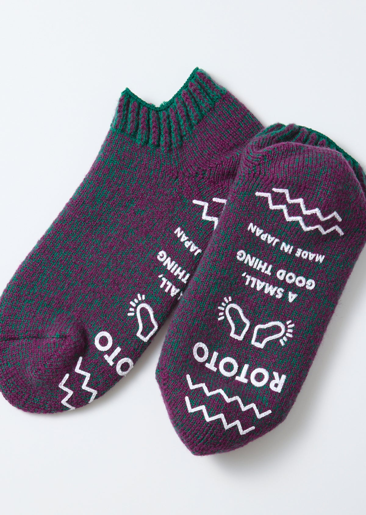 Flat lay, top view of purple and green ROTOTO socks with white text and graphics.