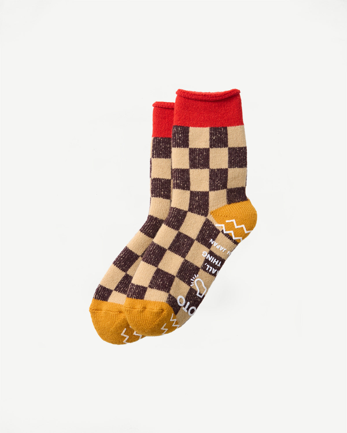 Close-up of a pair of checkered pattern socks with red cuffs and mustard yellow toes.