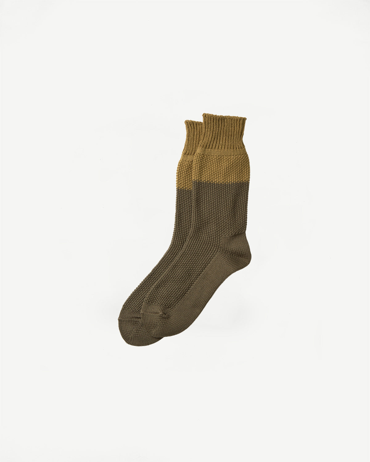 Rototo R1610 seed stitch socks in dark olive, flat lay view of front side, textured knit.
