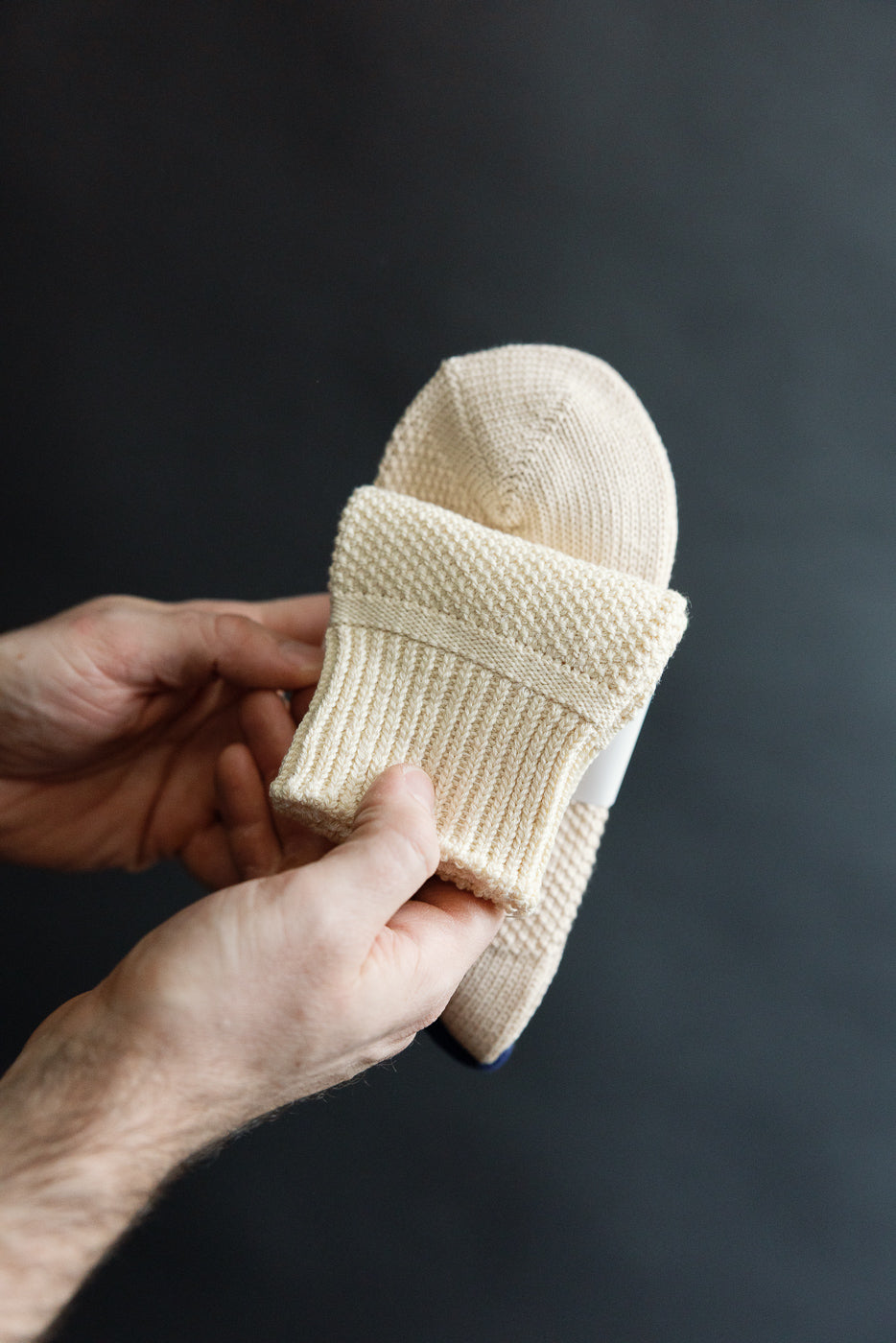 Close-up of raw beige Rototo seed stitch socks, front view, showing knit texture at Dant