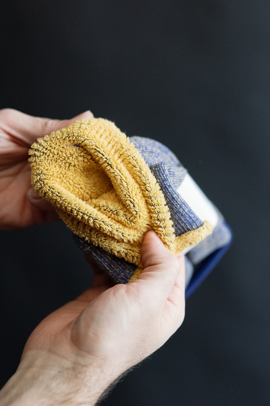 Close-up of blue and yellow RoToTo reversible pile sock interior fabric texture, front view