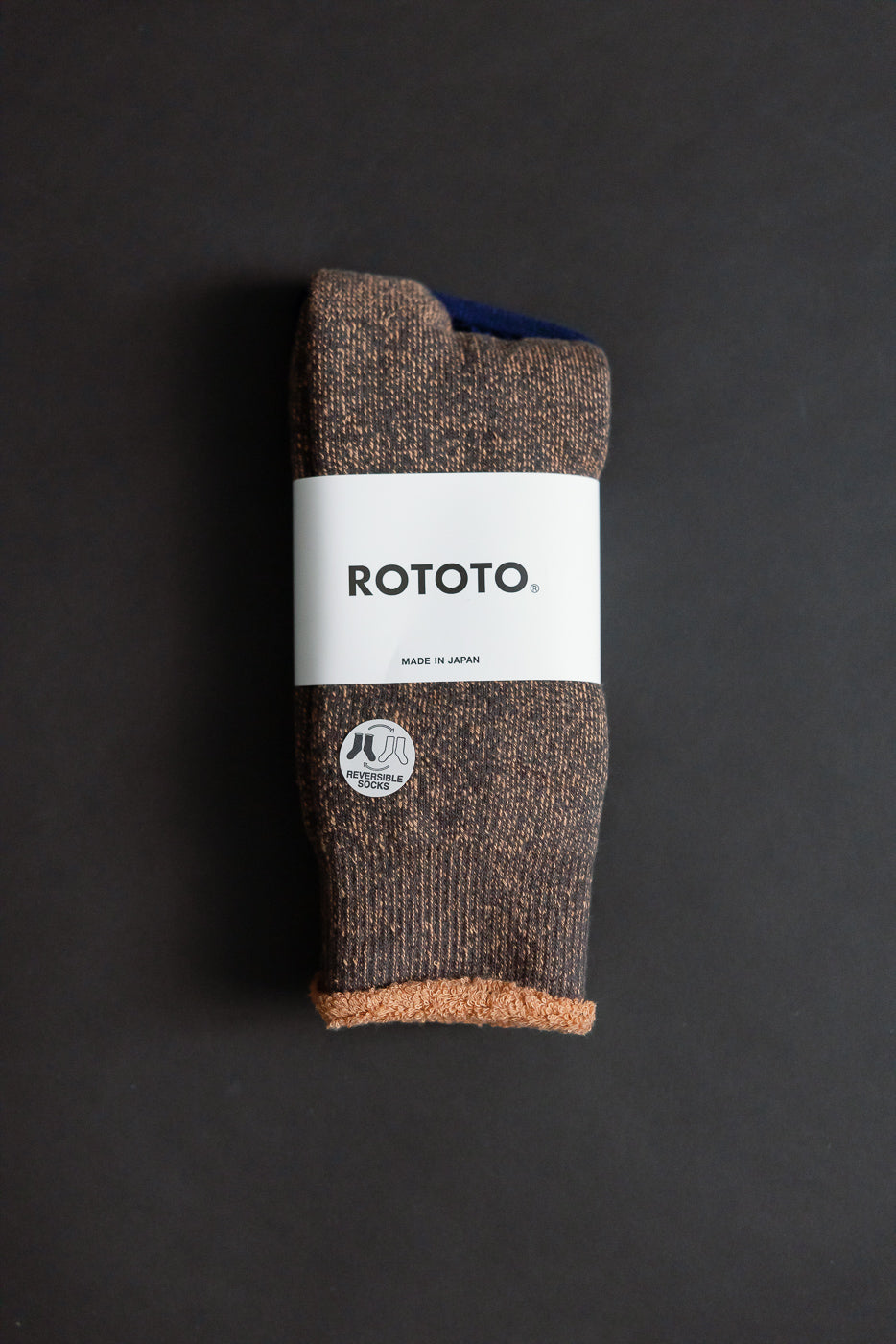 R1612 - Reversible Pile Socks - Faded Black, Light Orange, featuring a folded pair with brown-speckled design, wrapped in a branded ROTOTO band, showcasing reversible functionality with a contrasting two-tone look.