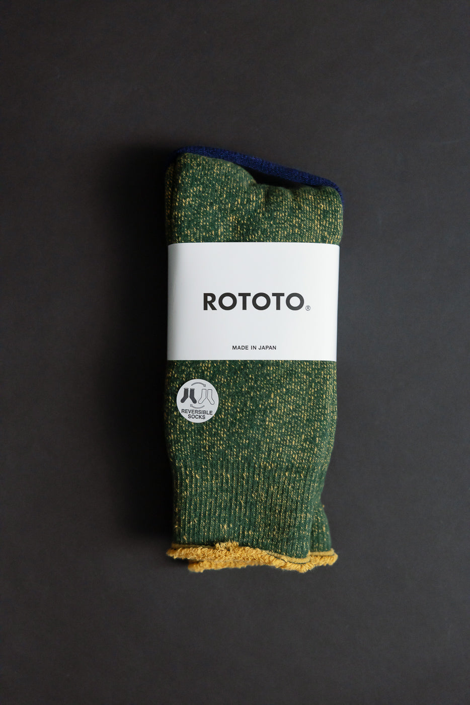 R1612 - Reversible Pile Socks in Ivy Green, Dark Yellow, featuring a speckled knit with yellow terry interior. Wrapped in ROTOTO band, showcasing reversible design inspired by 1970s college T-shirts.