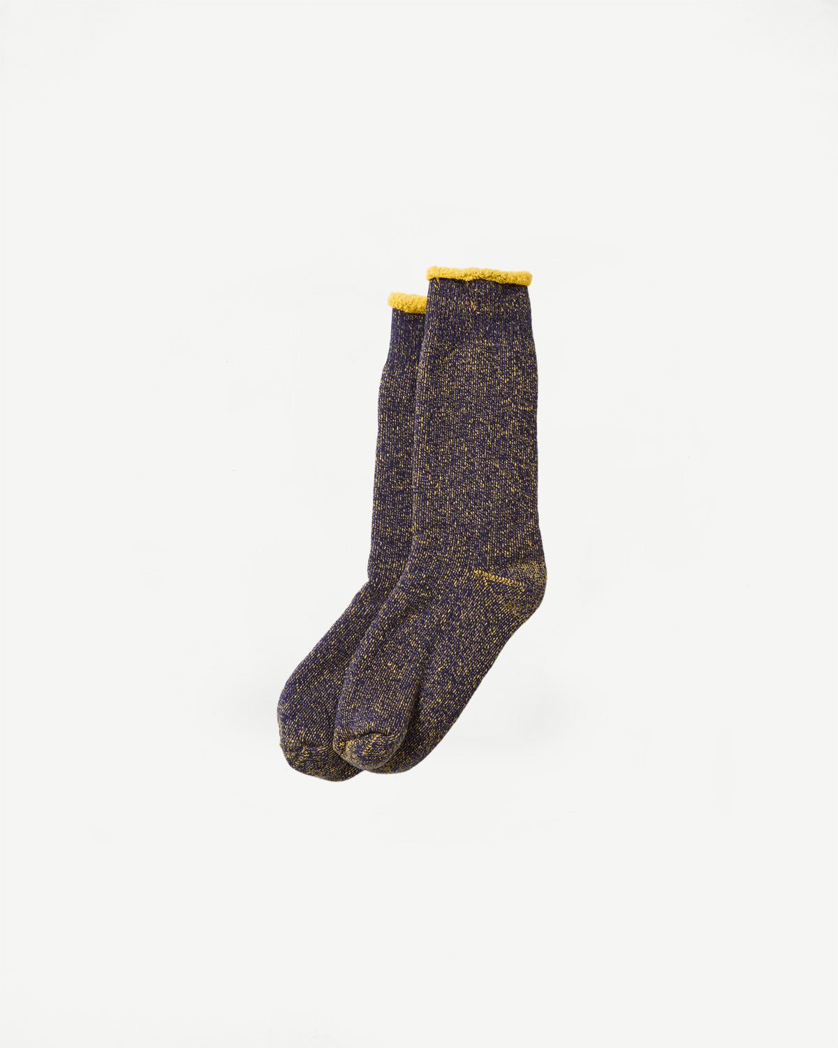 Flat lay of Rototo reversible pile socks in navy and yellow, showing front and top texture detail