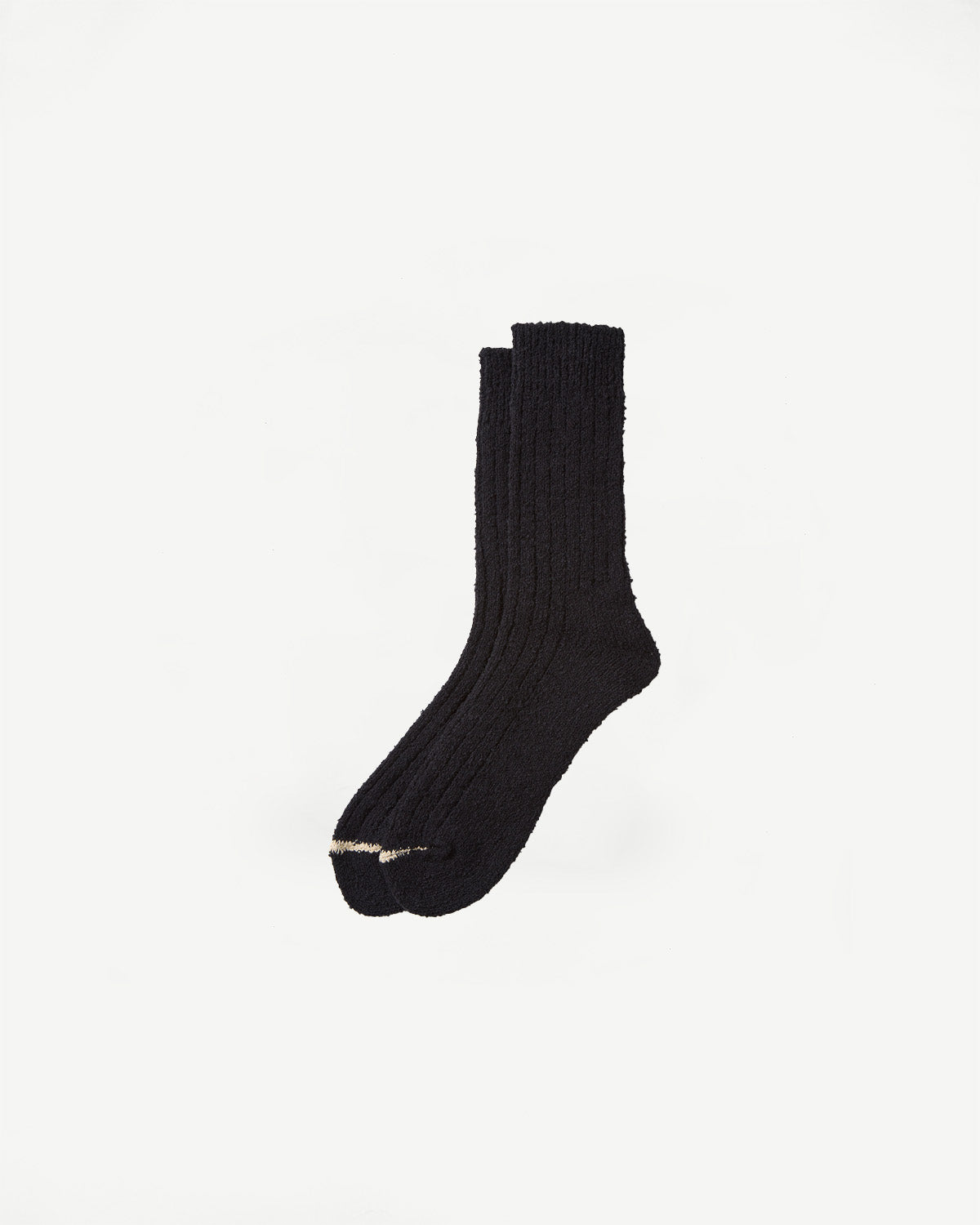 Flat lay of black Rototo recycled cotton boucle crew socks, front view, textured ribbed fabric, Dant store.