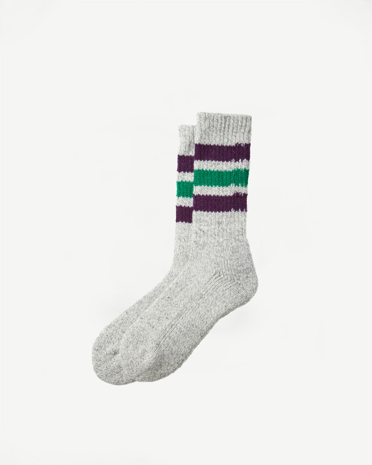 Close-up side view of a pair of grey crew socks with purple and green stripes.