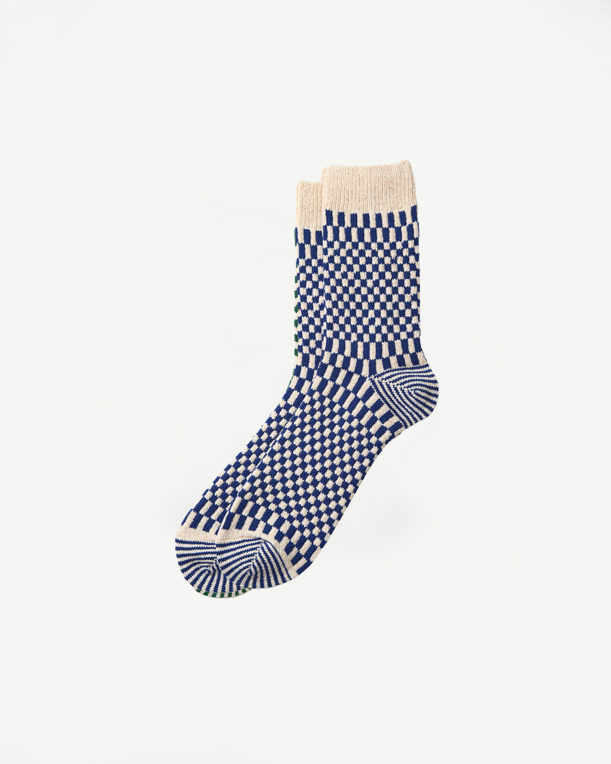 Flat lay front view of crew socks with blue and cream checkerboard pattern and ribbed cuff.