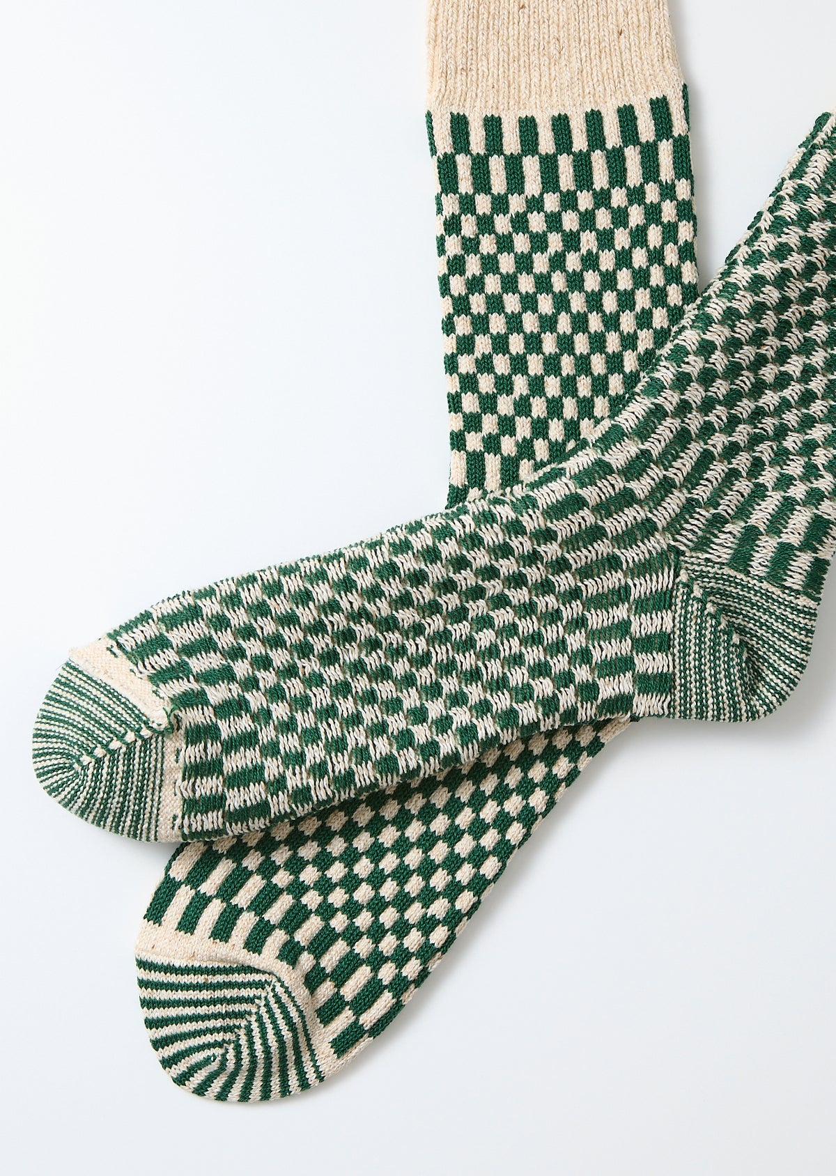 R1621 - Checkerboard Pattern Crew Socks - Green feature a cream and forest-green checkerboard design, with striped detailing on the toe and heel, emphasizing Rototo's quality craftsmanship and distinctive jacquard knit construction.