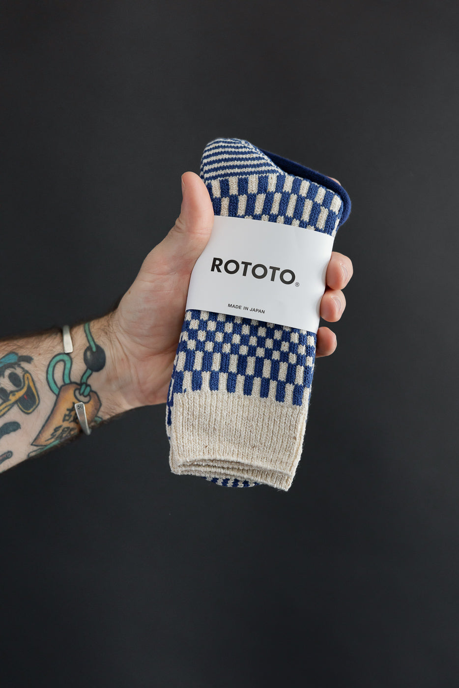 Close-up of front view showing blue and cream checkered pattern Rototo socks.