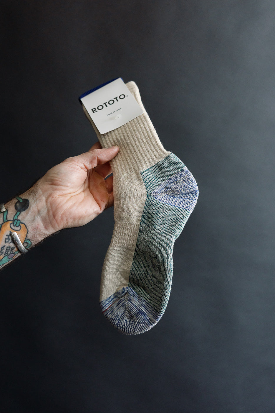 Close-up of natural Rototo R1632 Merino pile sock, front side, showing ribbed texture and contrasting toe and heel.