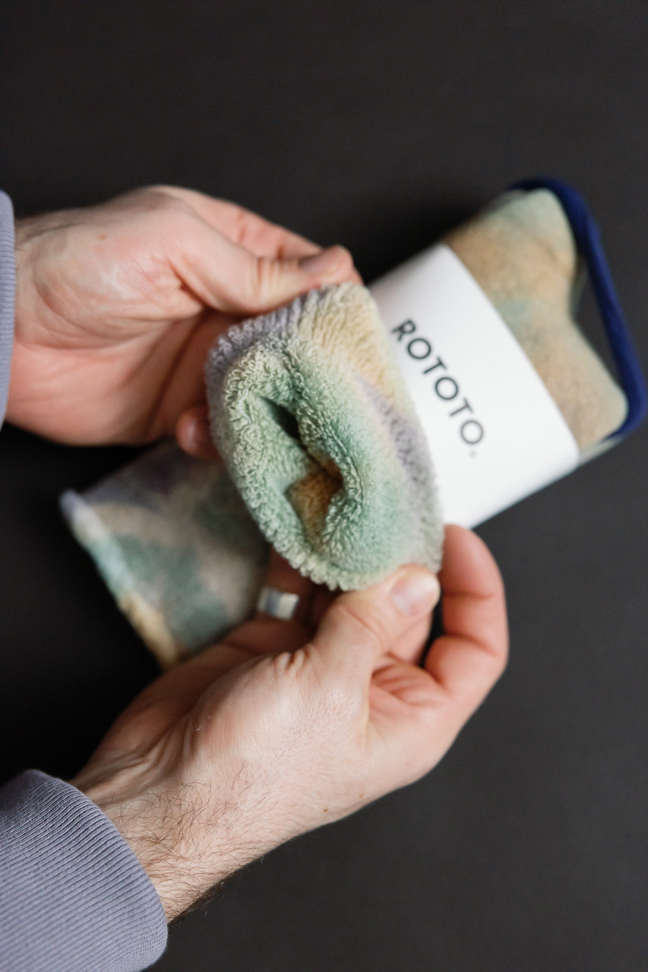 Close-up of green, light pink, and purple tie-dye crew socks showing soft pile texture, viewed from the opening. No model shown.
