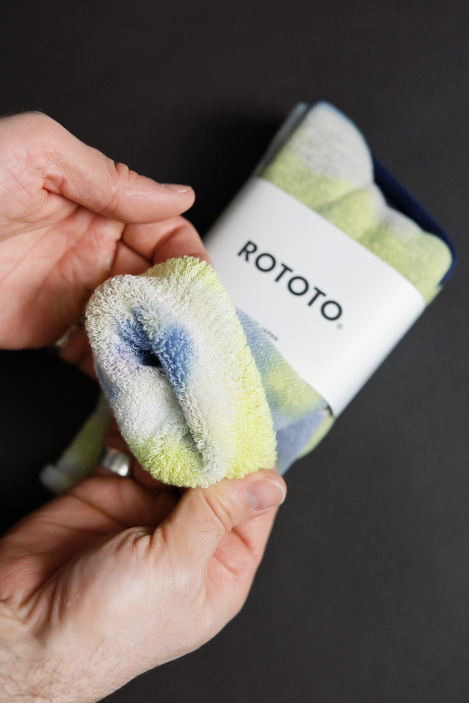 Close-up of tie-dye pile crew socks in green, lime, and blue, showing plush fabric texture.