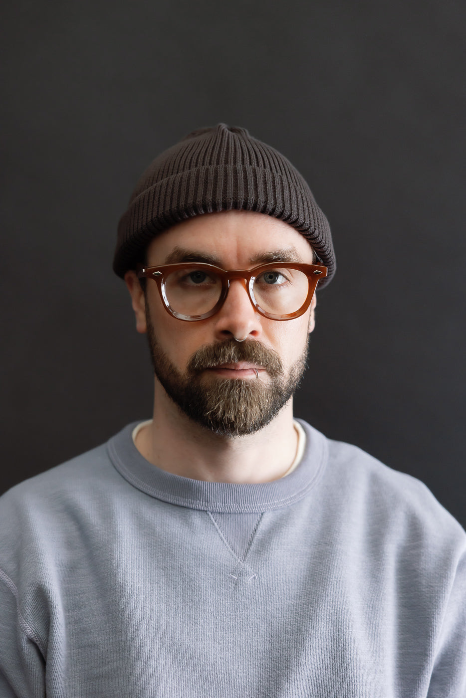 Front close-up of dark brown cotton roll up beanie on male model, 5'9