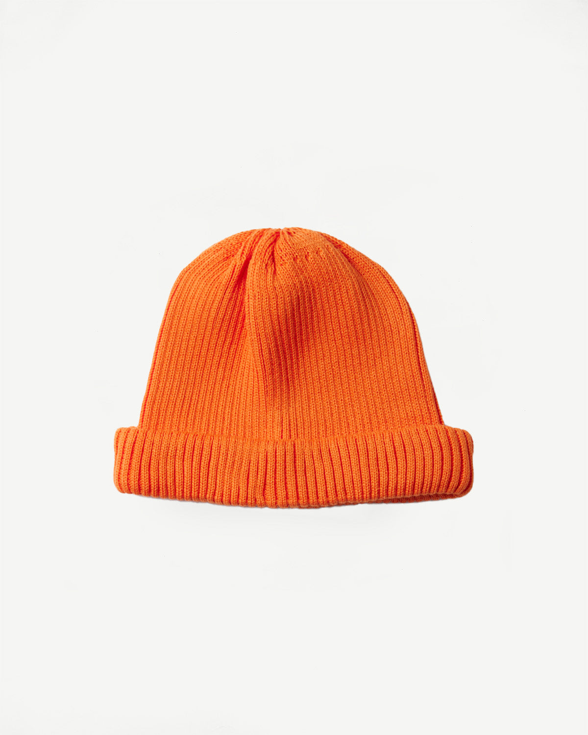 R5021 - Cotton Roll-Up Beanie - Orange. A shallow-cut, bright orange rib-knit beanie designed to sit above the ears with a rolled-up hem, offering a snug, stylish fit.
