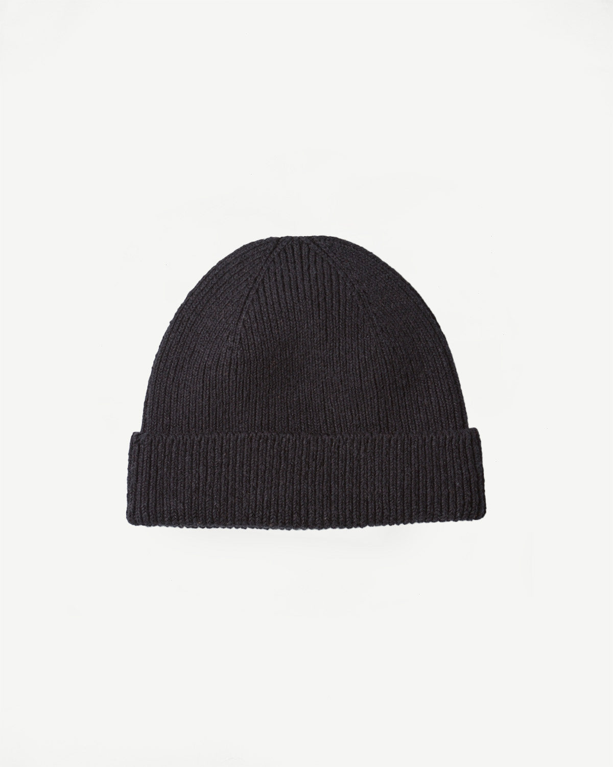 Front flat lay of black knit beanie, showing ribbed cuff and textured cotton fabric.