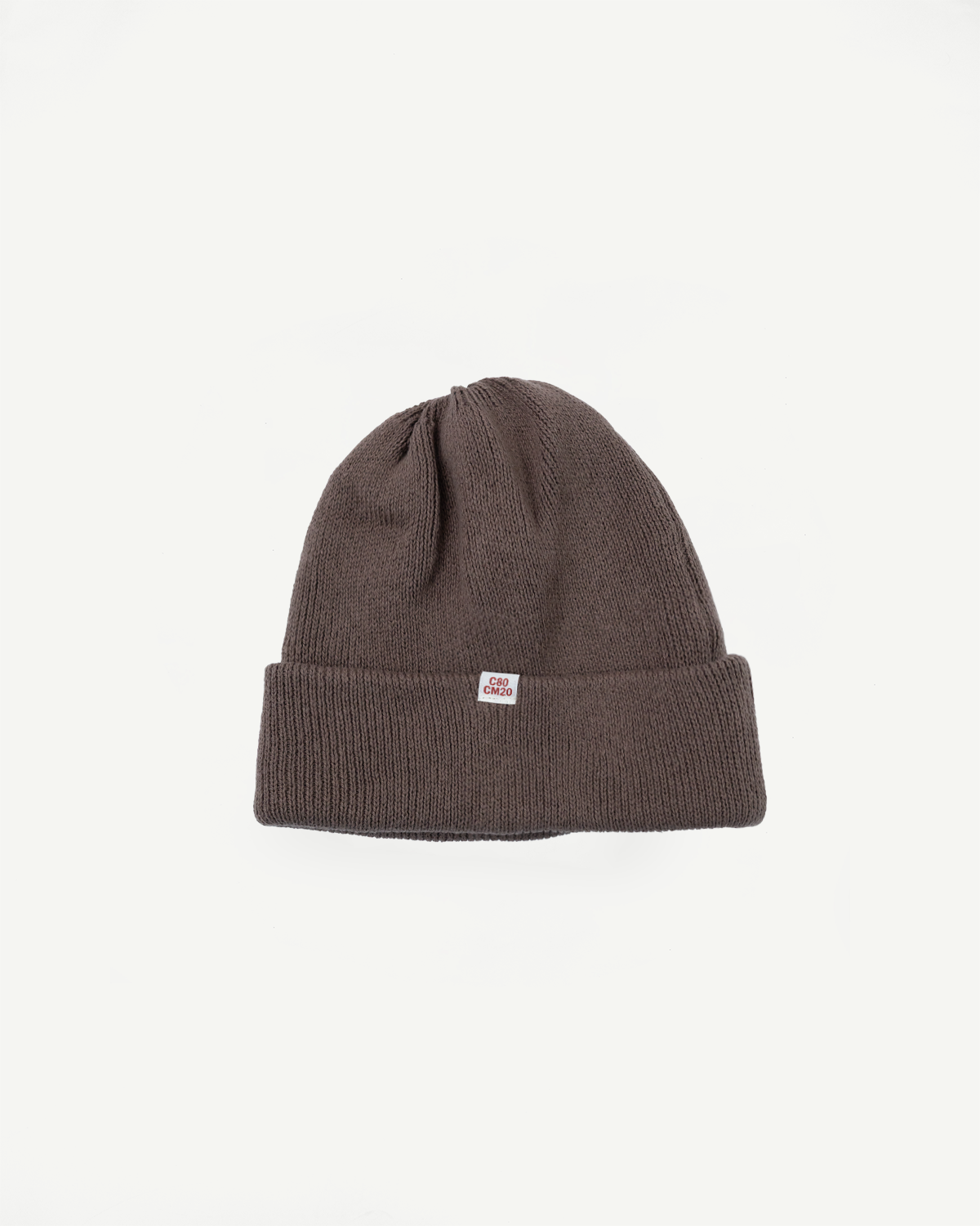 Close-up front view of a brown ribbed knit beanie featuring a small white C60 CM20 tag.