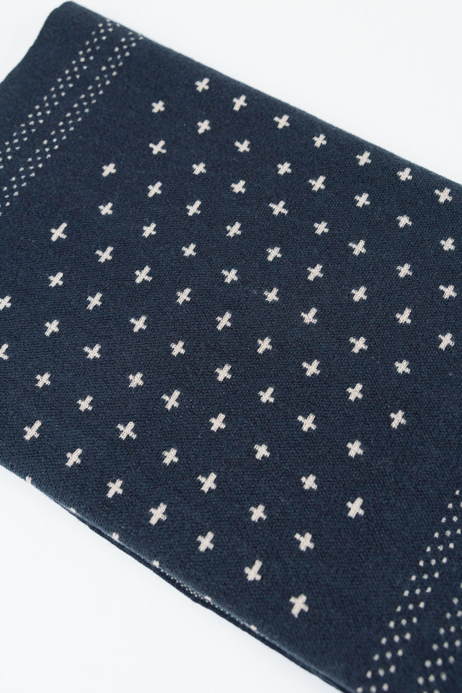 Close-up of the front fabric texture showing a navy blue pattern with small white crosses.