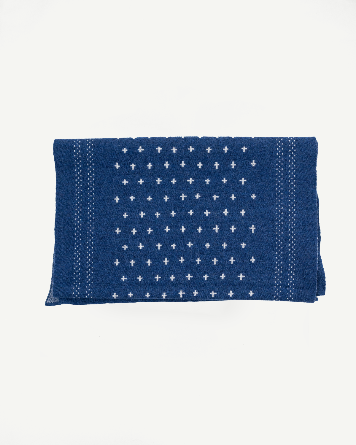 Front view flat lay of a blue patterned dish towel with white cross motifs.
