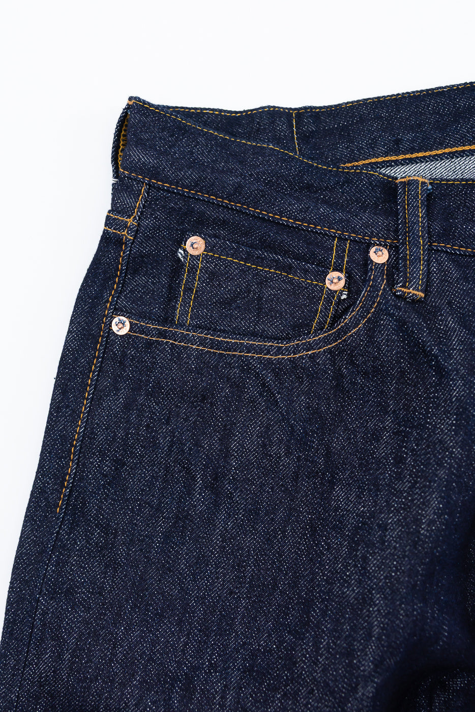 Close-up of front left hip and pocket, Samurai 15oz washi selvedge denim jeans, gold stitching, copper rivets