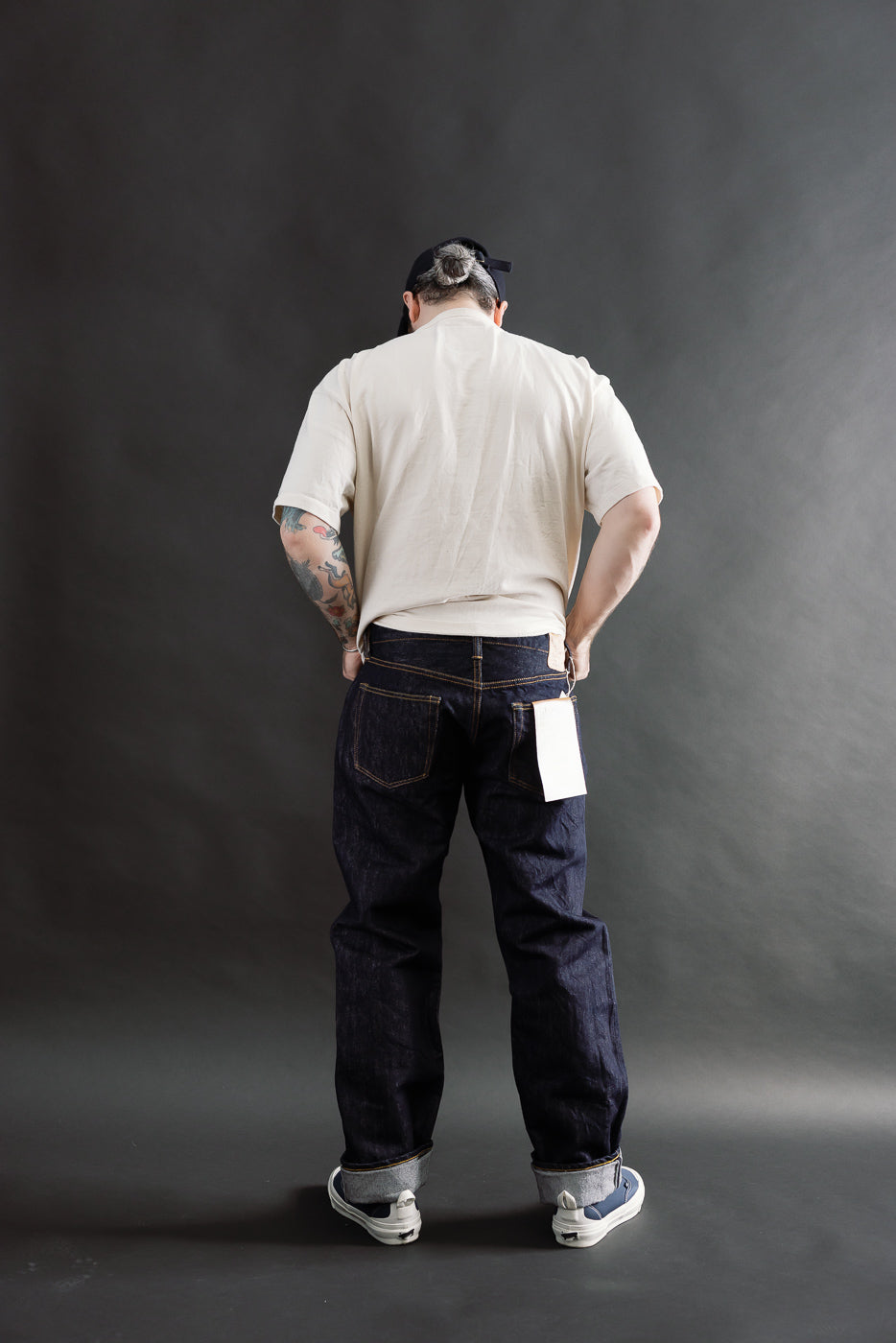 Full body rear view of male 5'9, 165lbs in slim straight 15oz selvedge denim jeans, Dant shop