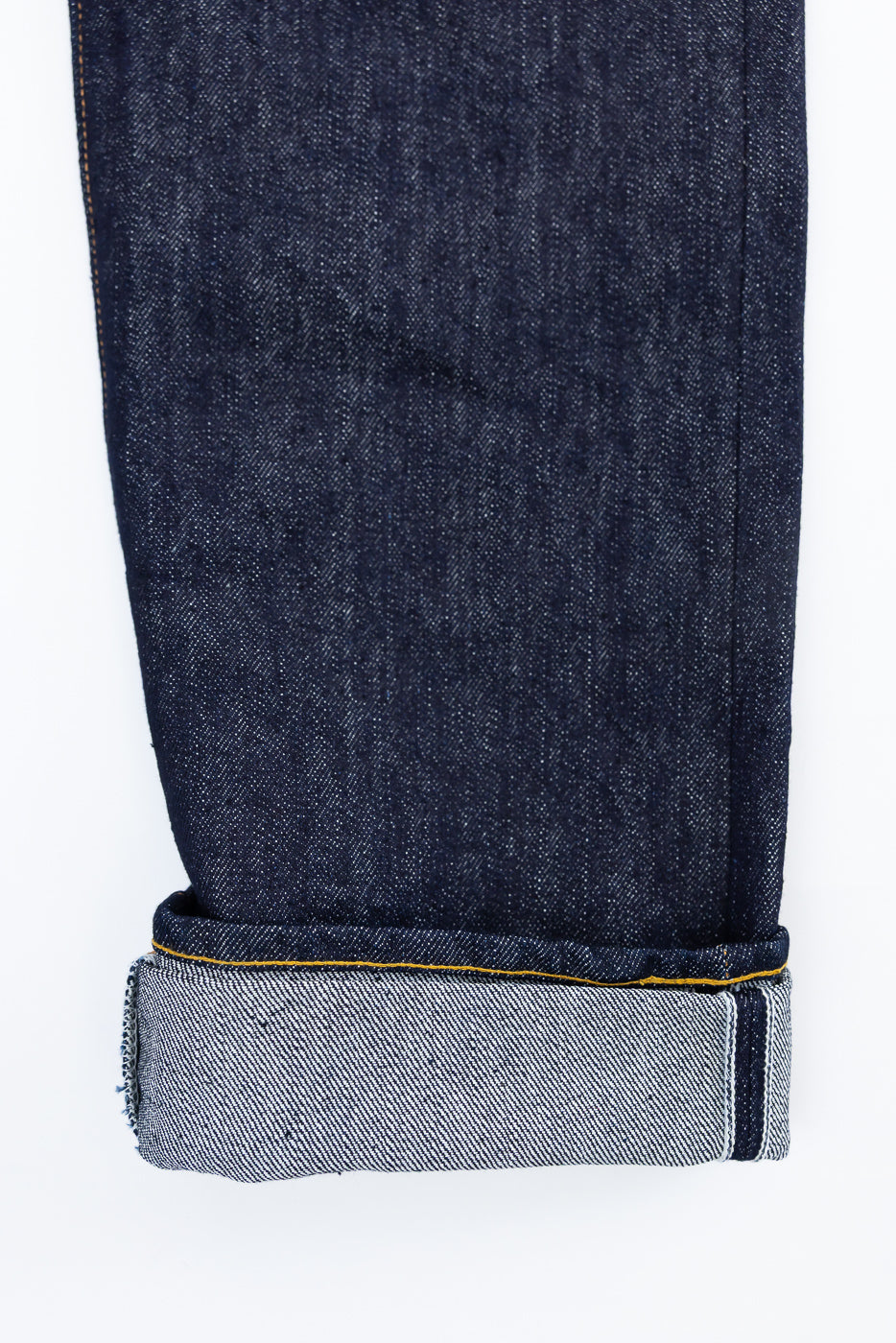 Close-up of front lower leg and cuff on Samurai S0710xx 15oz washi selvedge denim, highlighting fabric and hem details.
