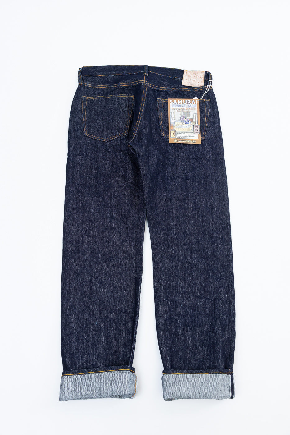 Flat lay of Samurai S0710xx 15oz limited washi selvedge denim jeans, back side, showing pockets and tags